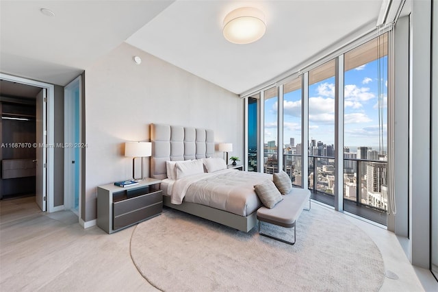 carpeted bedroom with a wall of windows and access to exterior