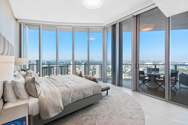 bedroom with multiple windows, access to exterior, and floor to ceiling windows