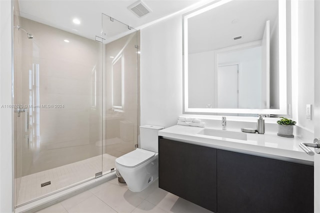 bathroom with toilet, walk in shower, vanity, and tile patterned floors