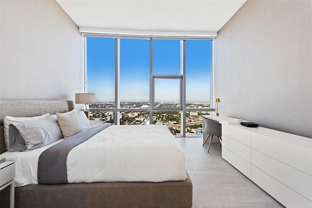 bedroom with multiple windows and a wall of windows