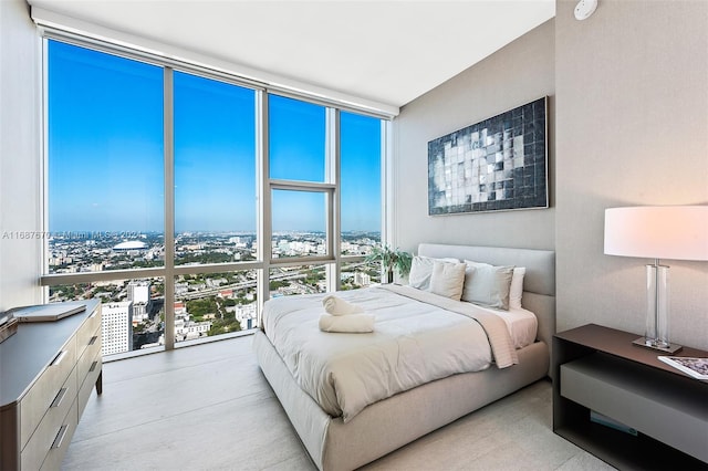 bedroom with multiple windows and a wall of windows