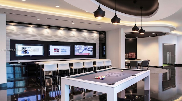 rec room featuring pool table, a tray ceiling, and dark tile patterned flooring