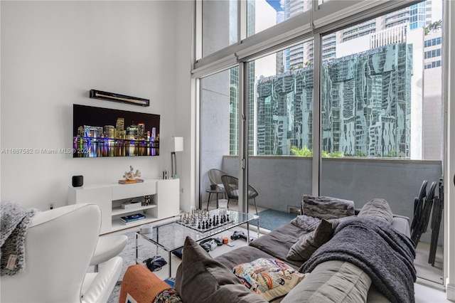 living room with a towering ceiling and a wealth of natural light