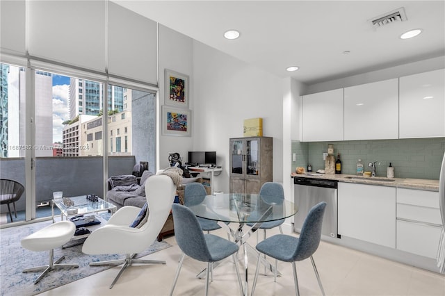 tiled dining area featuring sink