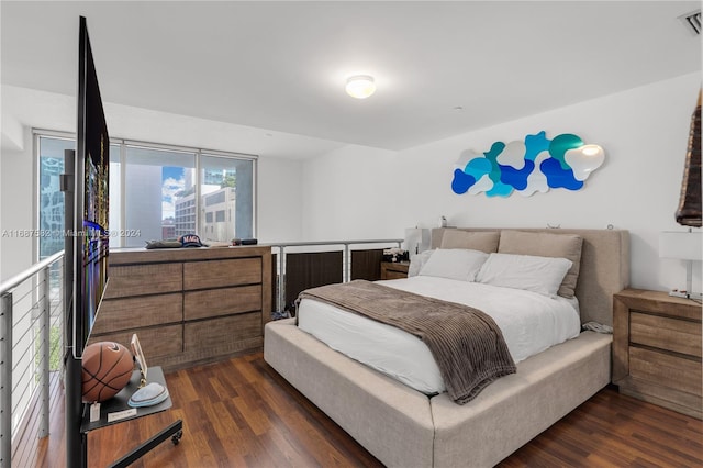 bedroom with dark hardwood / wood-style flooring