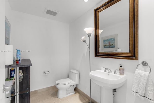 bathroom with toilet and tile patterned flooring