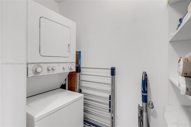 washroom featuring stacked washer / dryer