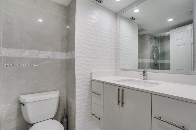 bathroom with walk in shower, vanity, toilet, and tile walls