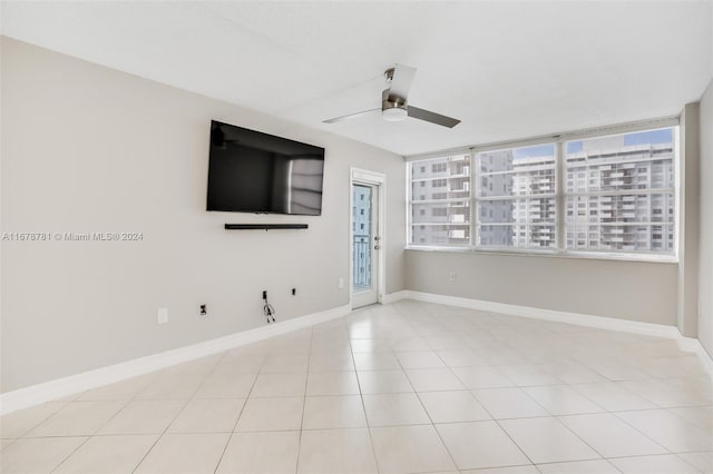 spare room with light tile patterned floors and ceiling fan