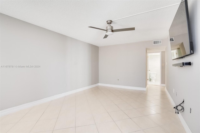 spare room with ceiling fan and a textured ceiling