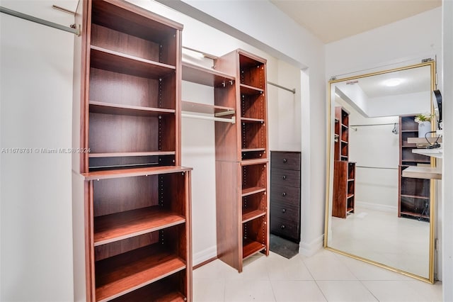 walk in closet with tile patterned flooring