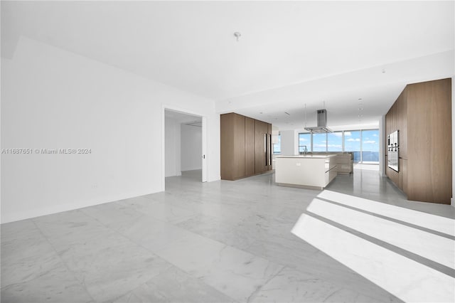 unfurnished living room featuring sink