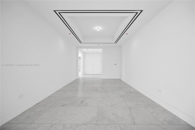 hallway with a tray ceiling