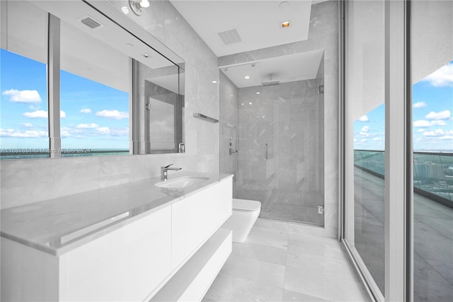 bathroom with toilet, an enclosed shower, vanity, and tile patterned floors