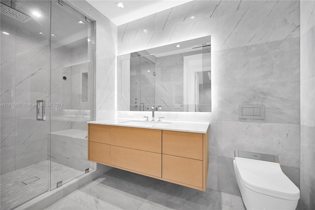 bathroom featuring toilet, vanity, tile walls, and a shower with shower door