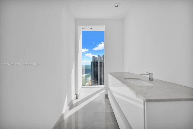 bathroom featuring a water view and sink