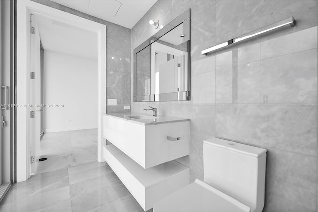 18501 Collins Ave Unit 4003/04, Sunny Isles Beach, FL 33160 - bathroom with tile walls, marble finish flooring, vanity, and toilet