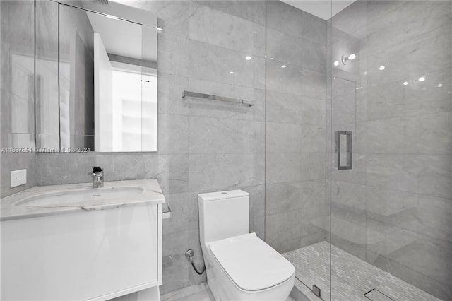 bathroom featuring vanity, toilet, an enclosed shower, and tile walls