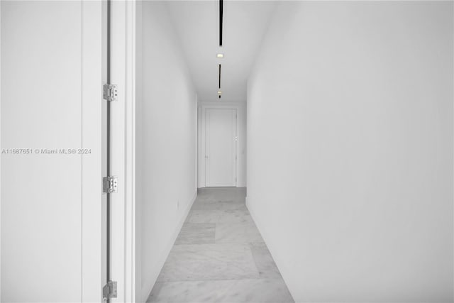 18501 Collins Ave Unit 4003/04, Sunny Isles Beach, FL 33160 - hallway with light marble finish flooring, baseboards, and attic access