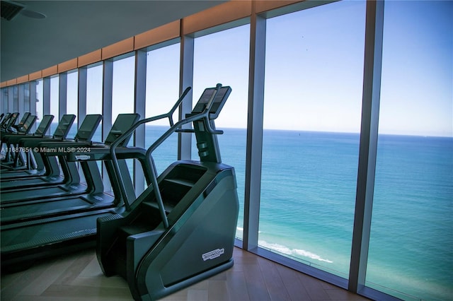 workout area featuring a water view