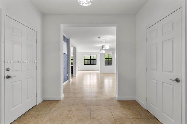 corridor featuring light tile patterned floors