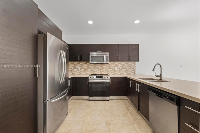 kitchen featuring decorative backsplash, kitchen peninsula, dark brown cabinets, stainless steel appliances, and sink