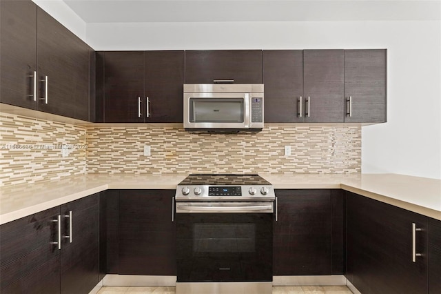 kitchen featuring appliances with stainless steel finishes, tasteful backsplash, dark brown cabinets, and light tile patterned floors