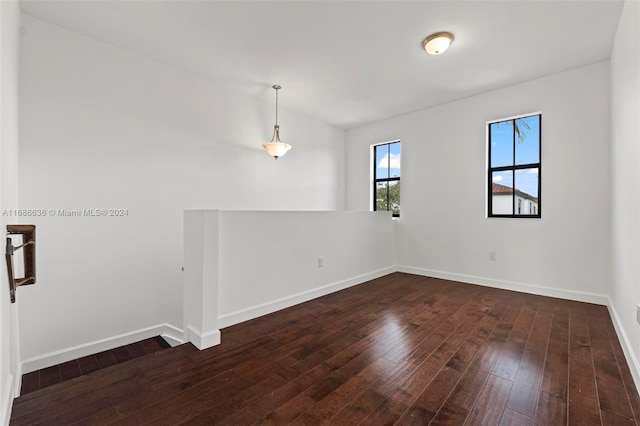 spare room with dark hardwood / wood-style flooring