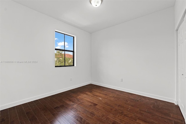 empty room with hardwood / wood-style flooring