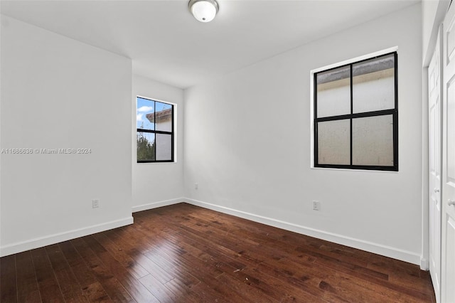 unfurnished room featuring dark hardwood / wood-style flooring