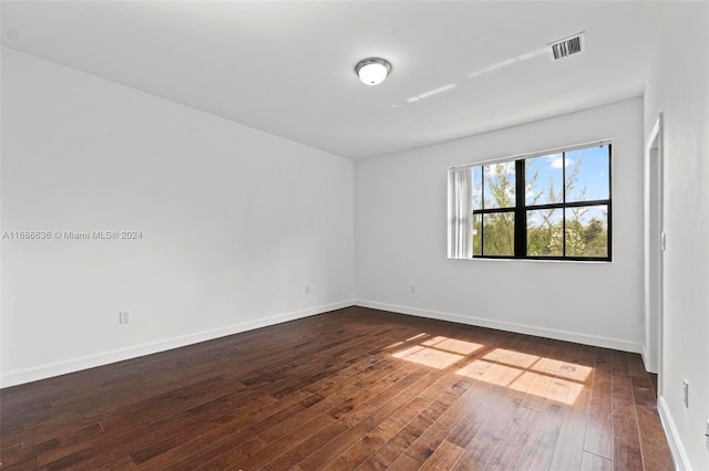 spare room with dark hardwood / wood-style flooring