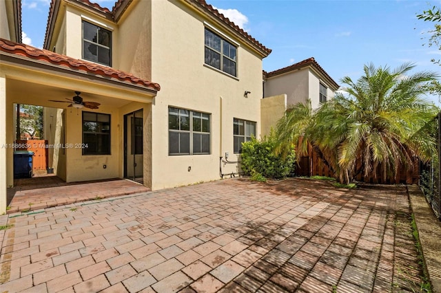 exterior space with ceiling fan