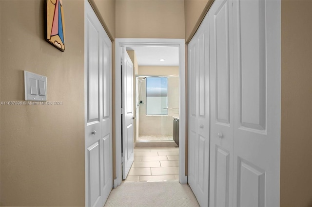 corridor featuring light tile patterned flooring