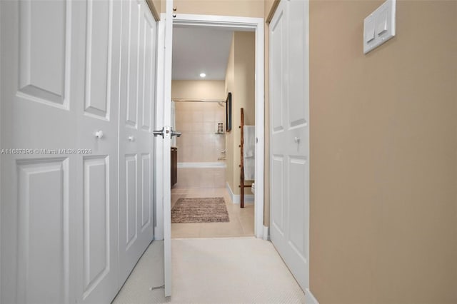 corridor with light tile patterned floors