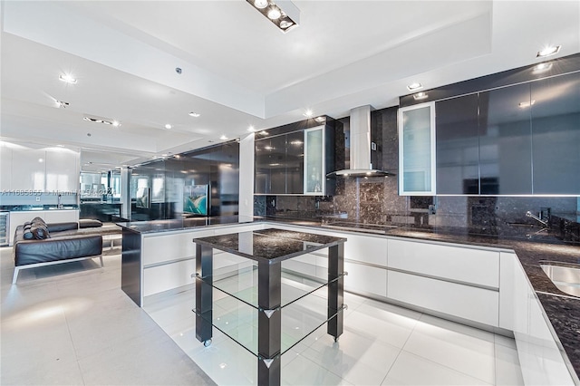 kitchen featuring white cabinets, light tile patterned floors, decorative backsplash, and wall chimney exhaust hood