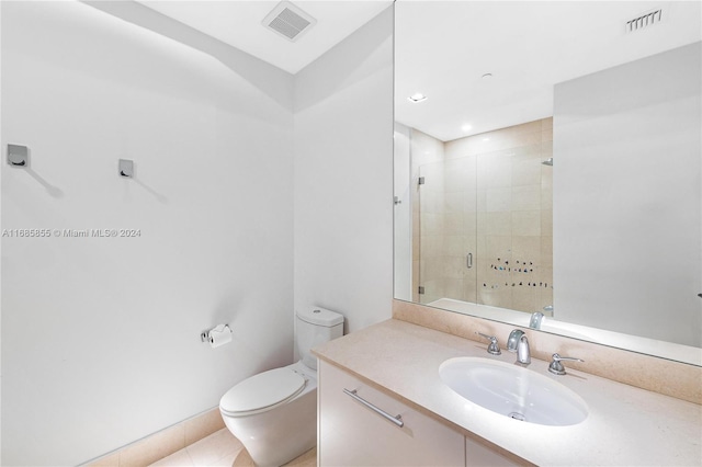 bathroom featuring tile patterned floors, vanity, an enclosed shower, and toilet