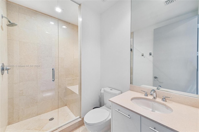 bathroom with an enclosed shower, vanity, and toilet