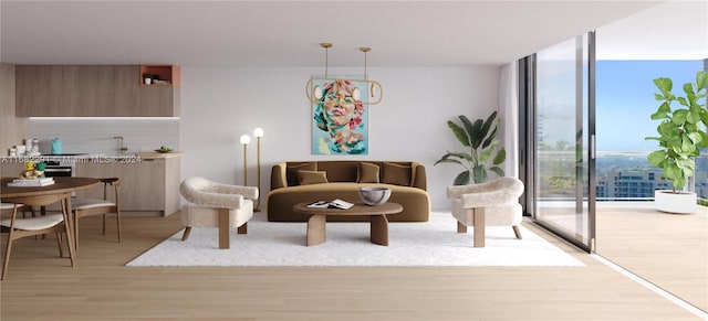 living room with light hardwood / wood-style flooring, expansive windows, and a notable chandelier