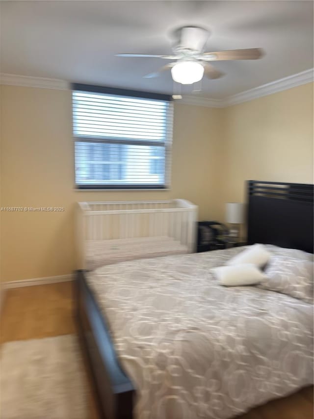 unfurnished bedroom featuring crown molding, ceiling fan, and hardwood / wood-style floors