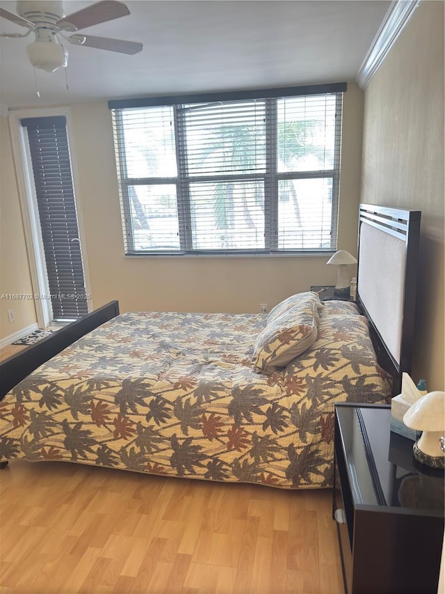 bedroom featuring crown molding, ceiling fan, and wood-type flooring