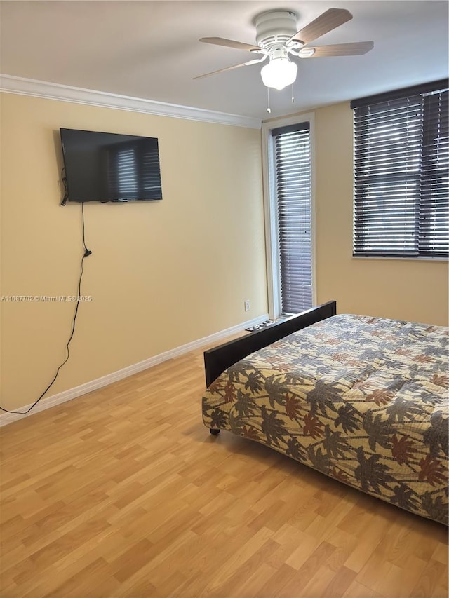 unfurnished bedroom featuring crown molding, ceiling fan, and light hardwood / wood-style floors