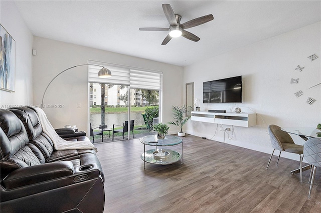 living room featuring ceiling fan and hardwood / wood-style flooring