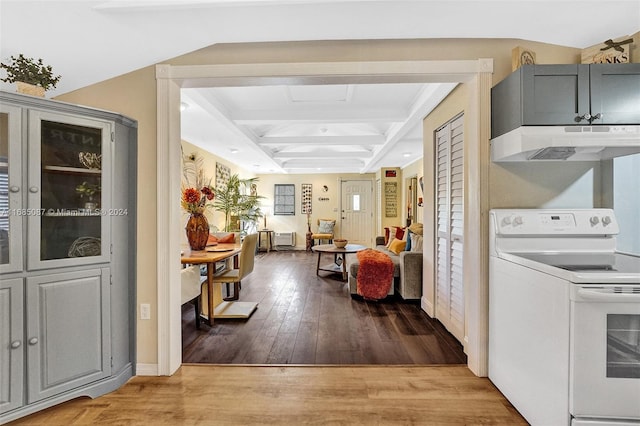 interior space featuring light wood-type flooring, coffered ceiling, and beam ceiling