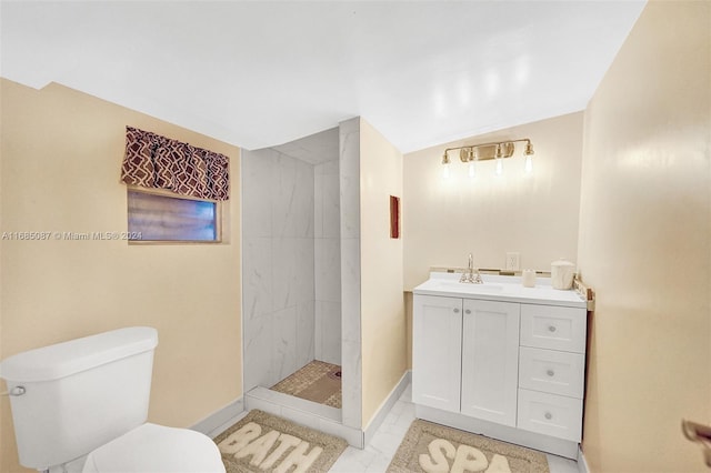 bathroom with tiled shower, tile patterned floors, toilet, and vanity