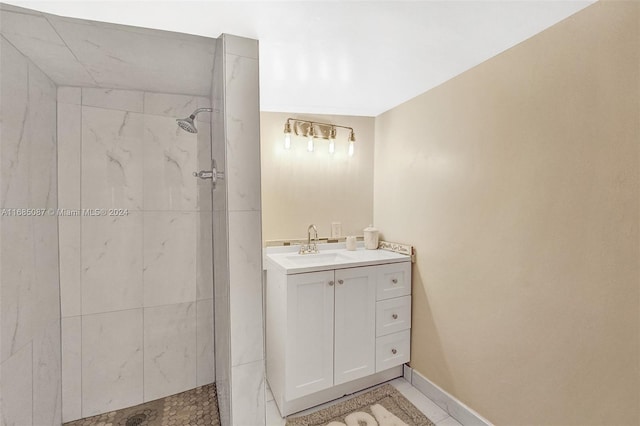 bathroom with vanity and a tile shower