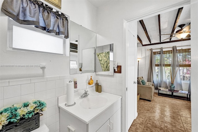 bathroom with tile walls, tile patterned flooring, vanity, and ceiling fan