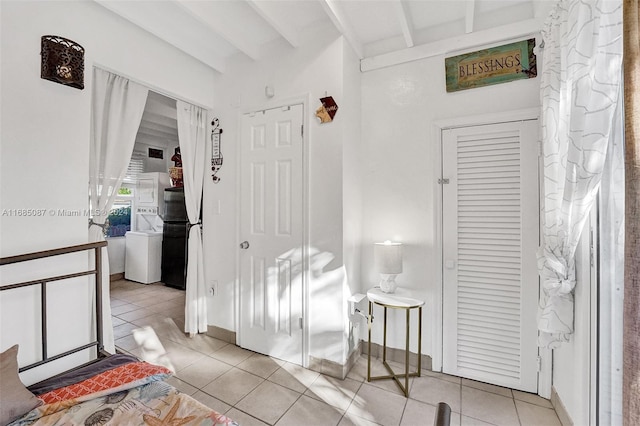 interior space with beamed ceiling and light tile patterned floors