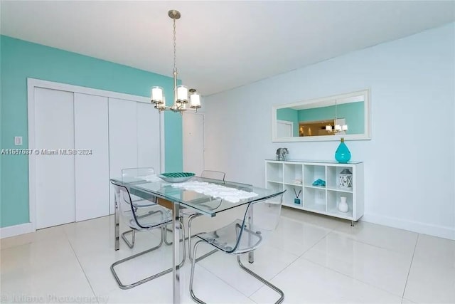 dining area with light tile patterned flooring and a chandelier