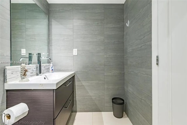 bathroom featuring tile walls, vanity, and tile patterned flooring