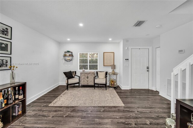 dining area with dark hardwood / wood-style flooring and a raised ceiling